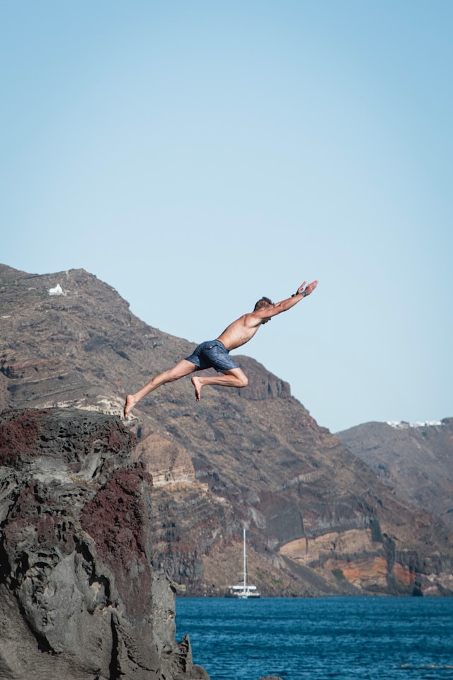 Man leaping from a cliff